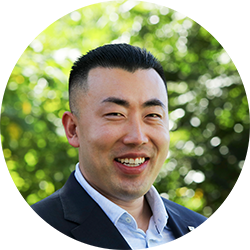 Jason Jiang wearing a suit and smiling