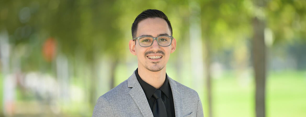 Dynami Martinez wearing a suit and smiling