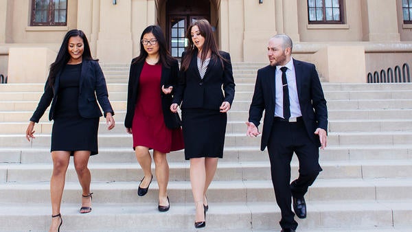students in business attire walking down stairs