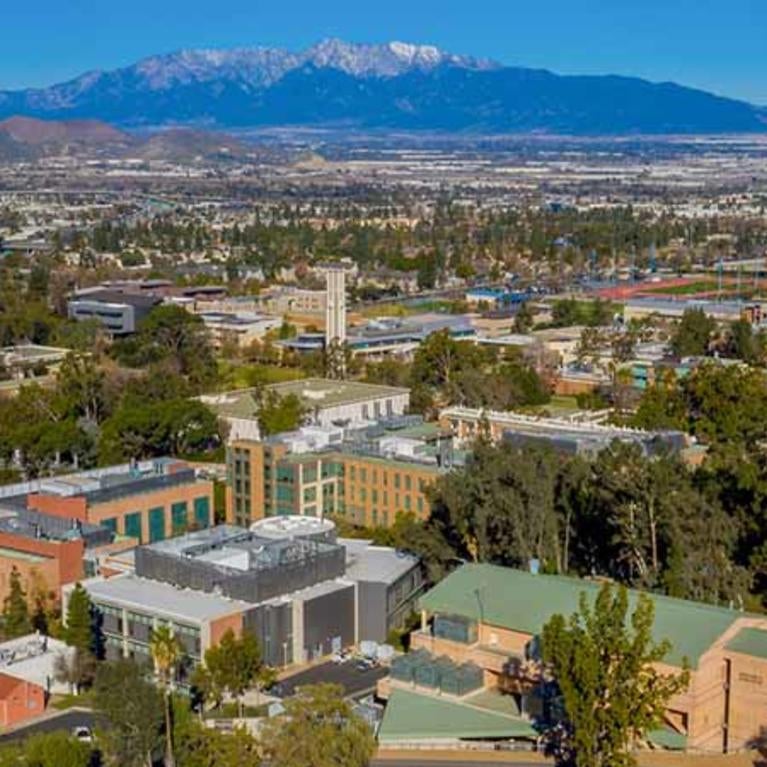 UC Riverside campus aerial view with snow capped mountains