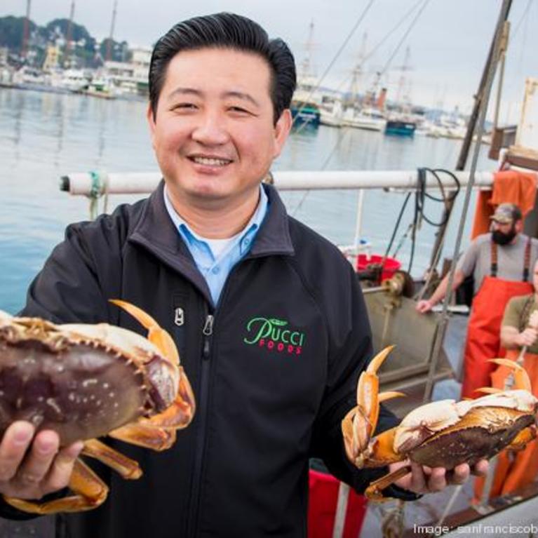 Chris Lam holding up a fresh crab