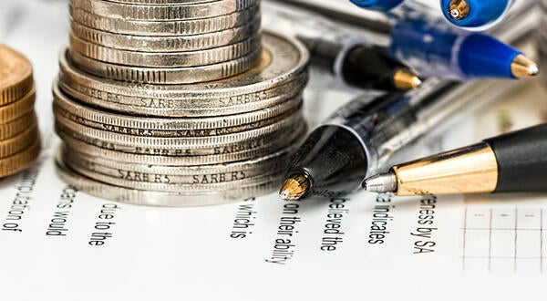 Coins and pencils on tax preparation papers