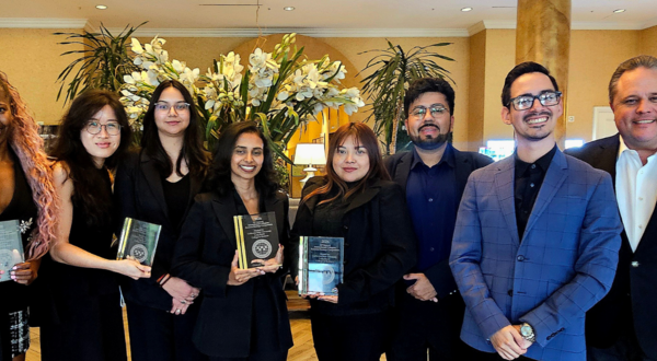 Professor Sean Jasso along with MBA students holding their awards for the International Collegiate Business Strategy Competition
