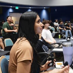 Female student in UCR Student Success Center auditorium