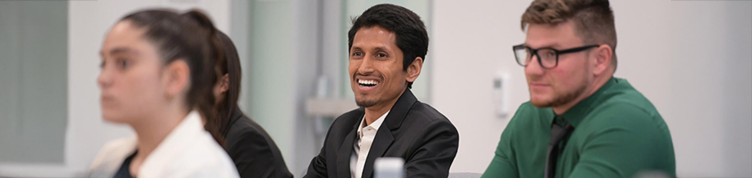 UCR Business student smiling during a presentation