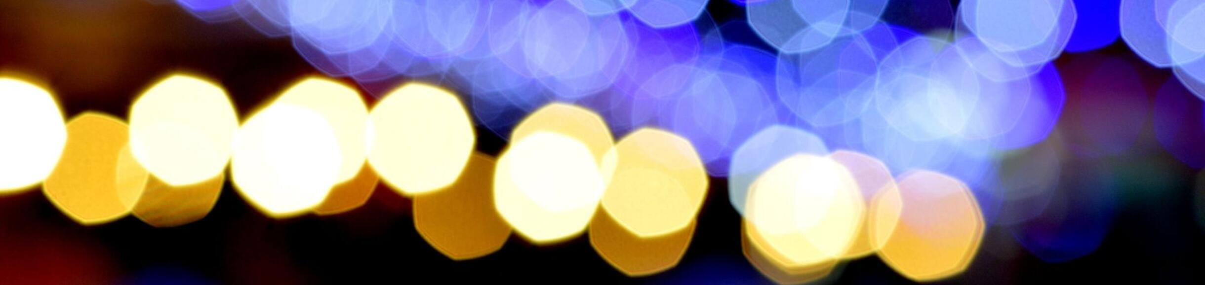 Illuminated night with blue and gold bokeh string lights