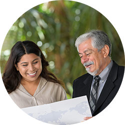 Faculty member and student viewing a UCR Business brochure