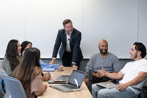 Group of Students Discussing with Professor