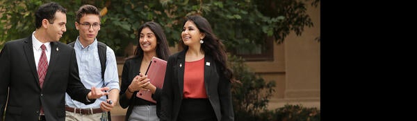 Undergrad students talking and walking outside