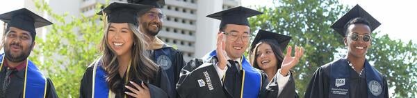 Business alumni celebrating at UCR bell tower