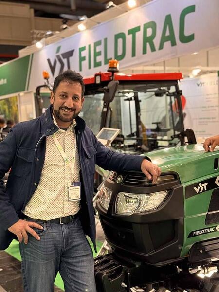 Arun in front of a tractor