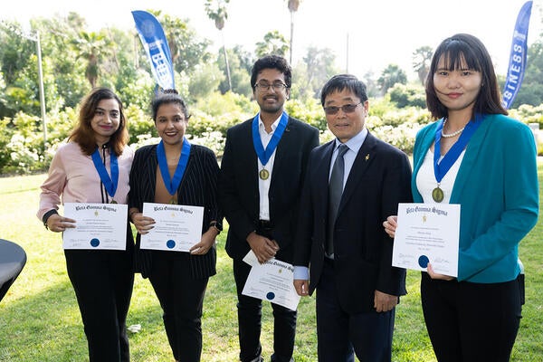 Beta Gamma Sigma inductees 2023 with Dean Yunzeng Wang