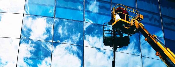 Worker washing windows