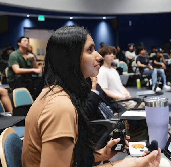 Female student in UCR Student Success Center auditorium