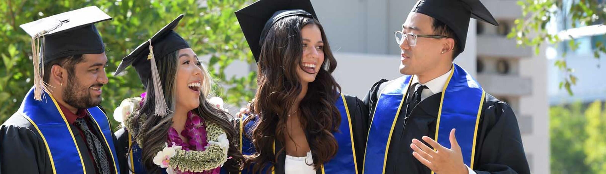 4 graduate students at Commencement 2022