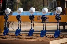5 shovels with bows and helmet, groundbreaking at UC Riverside