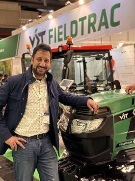 Arun Surendra ’99, ’01 MBA in front of a tractor