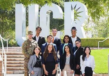 Business students in front of UCR sign