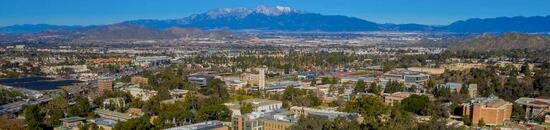 UC Riverside campus aerial view with snow capped mountains
