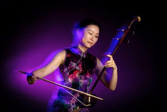 Chuan Qin playing the erhu.