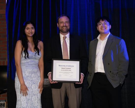 Michael Haselhuhn holding his award certificate.