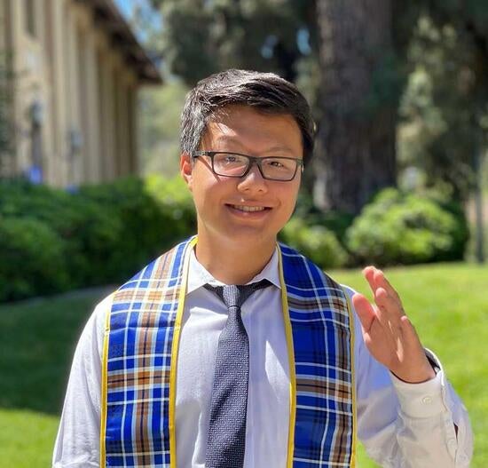 Joe Wu ’21, ’23 MBA in front of Anderson Hall, UCR School of Business