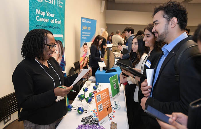 MBA candidates connecting with major employer Esri at an in-person career fair