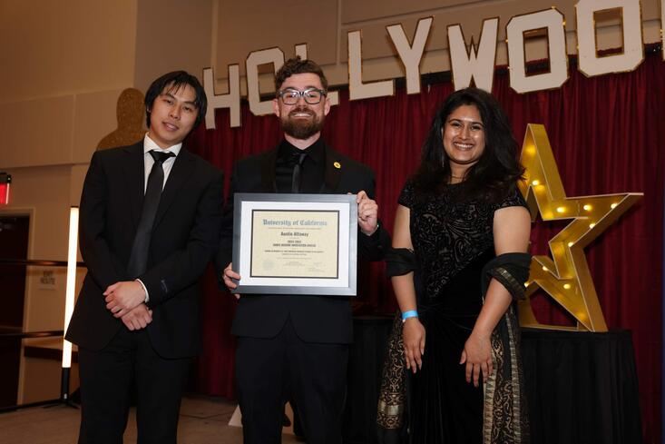Austin Attaway holding his James Merino Innovation Award
