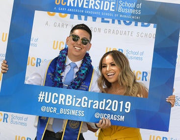 Two 2019 graduates having their photo taken